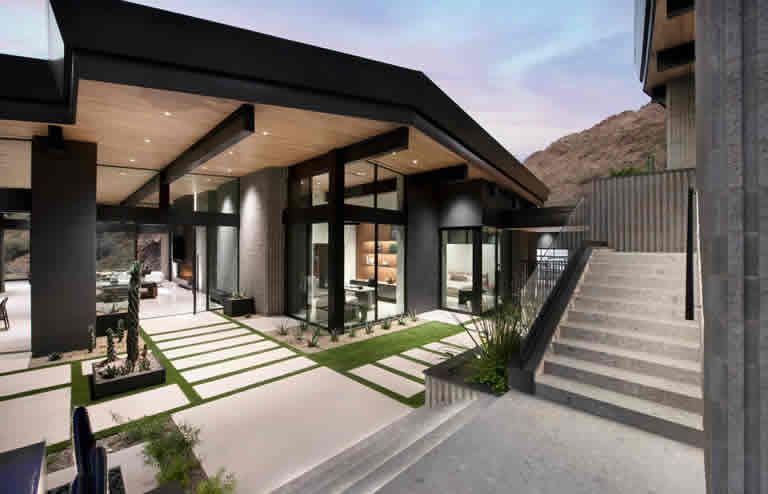 Contemporary luxury home exterior at night by a Phoenix custom builder